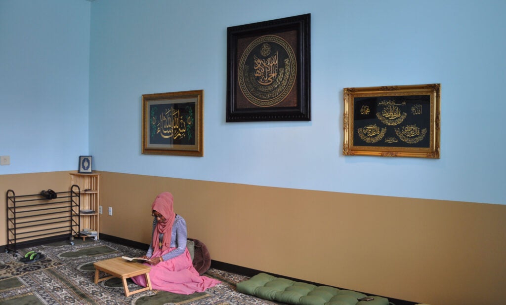 Woman praying in law center muslim prayer room