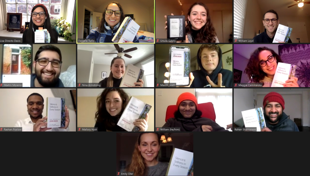 Zoom meeting screenshot A grid with headshots of 13 people Each person is holding a copy of John Main Daily Readings book