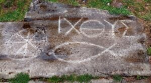 Ancient Christian Graffiti of two discrete symbols of Christian faith, a fish and ictus