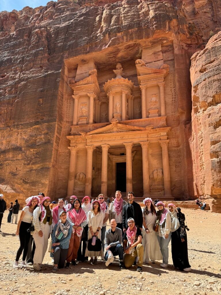 Students in Petra in front of ancient buildings