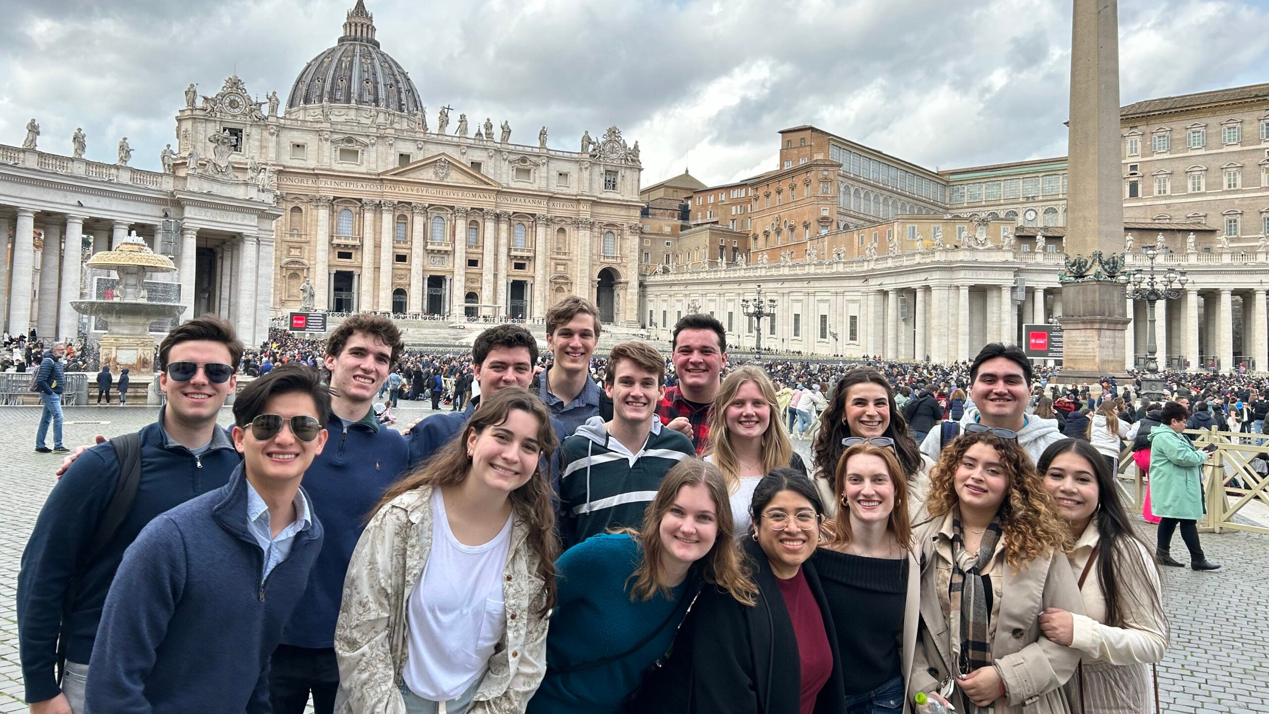 A group of students standing in St Peter's Square, Vatican City with Saint Peter's Basilica in the background.