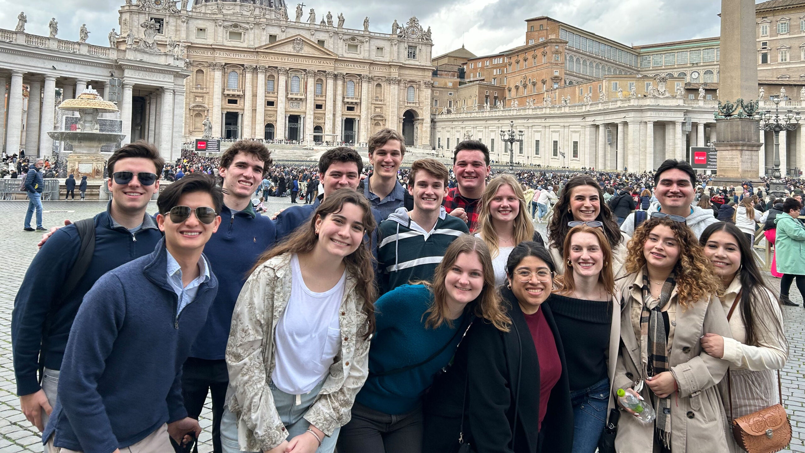 A group of students standing in St Peter's Square, Vatican City with Saint Peter's Basilica in the background.