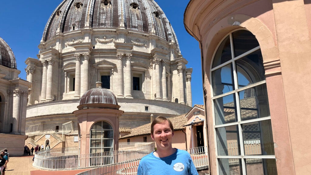 Headshot of Connor Hartigan in front of Saint Peters