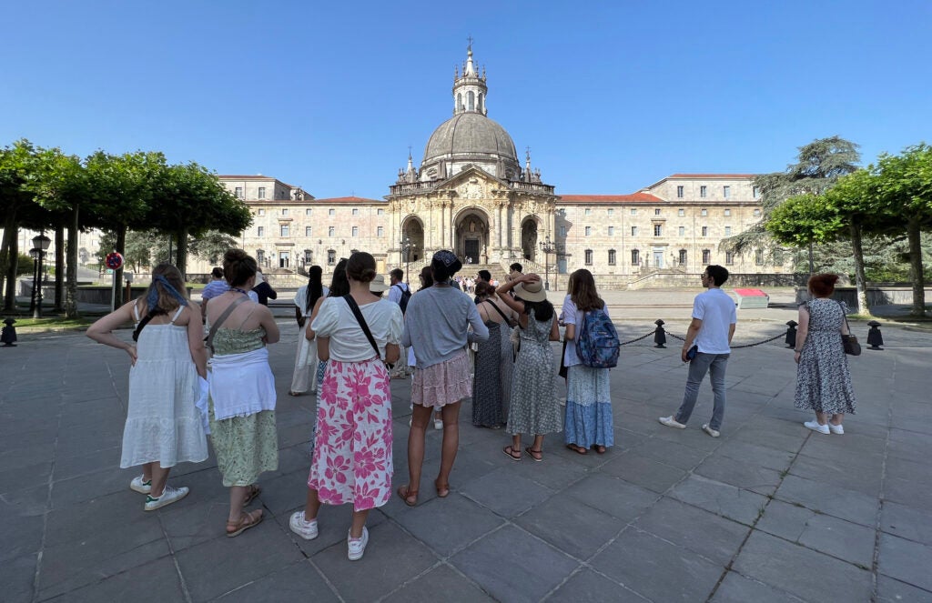 Students gathered around a historical site in Spain 