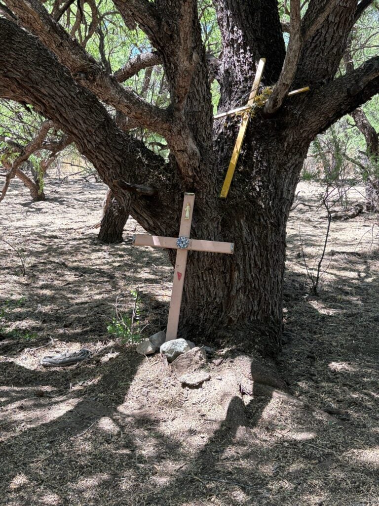 simple, hand made crosses left in the desert by asylum seekers