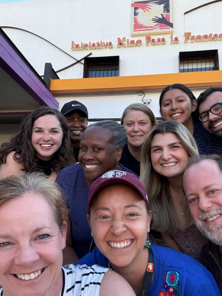 a group photo in front of the Kino Border Initiative.