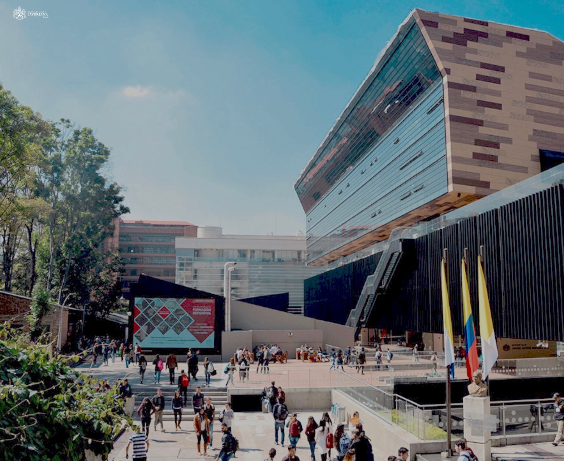 People walking around on a concourse on a campus in Colombia. 
