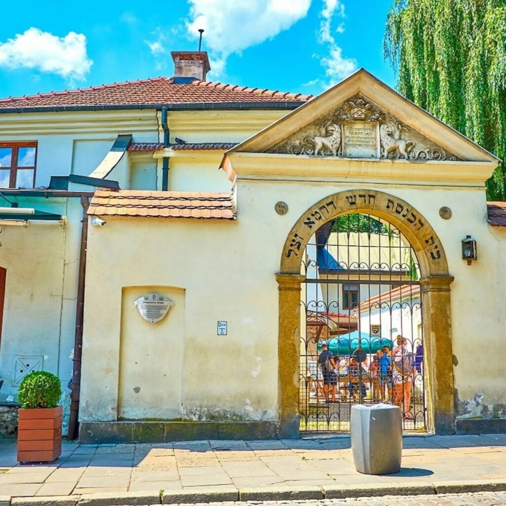 A yellow building with Hebrew written over the doorway. 