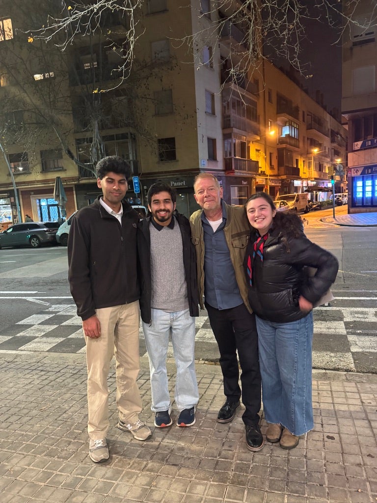 Four people posing for a picture on a street in Barcelona. 